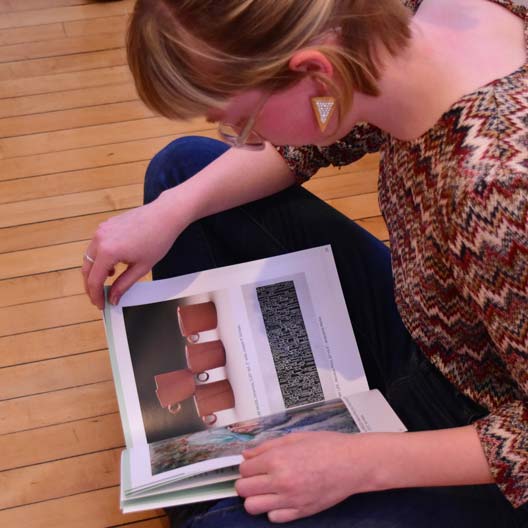A student reads Loomings Art Magazine