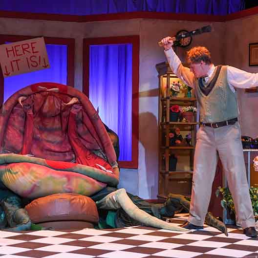 A student performs in Little Shop of Horrors