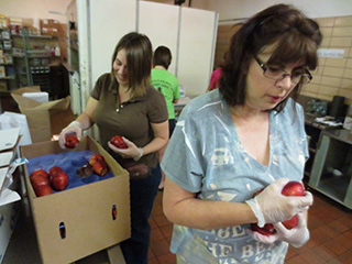 Hunger Coalition volunteers working in the Benedictine College Dining Hall kitchen