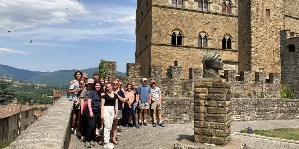 A group of students taking in the history and beautiful views of Italy.