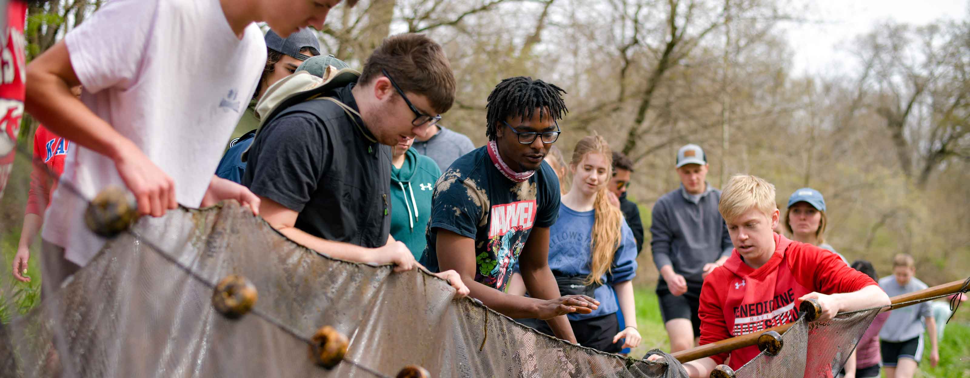 Students work with netting in a stream