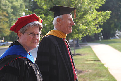 Dr. Douglas Brothers and Sister Linda Herndon, Ph.D. in academic regalia.