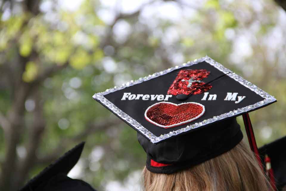 A graduate wears a decorated graduation cap