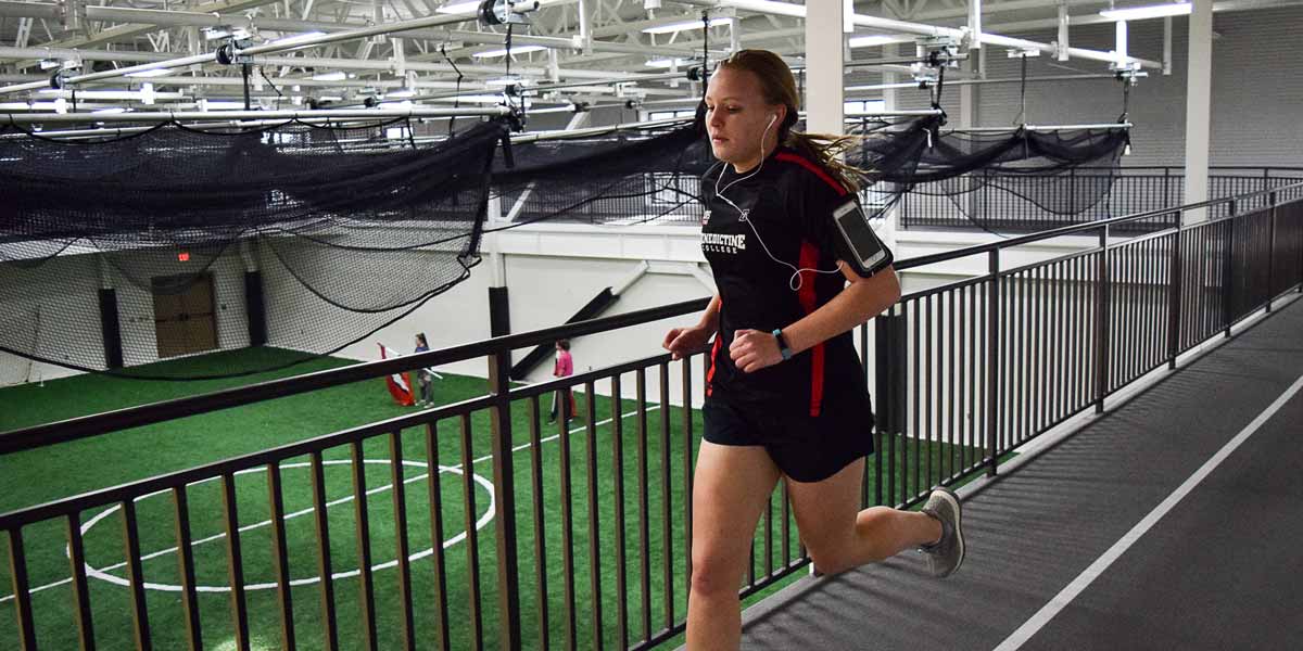 A student runs on a track in the Murphy Recreation Center