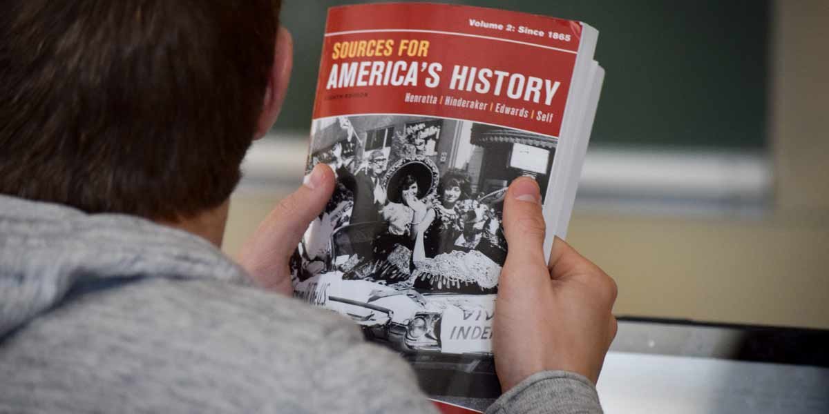 History A student holds a history textbook in class
