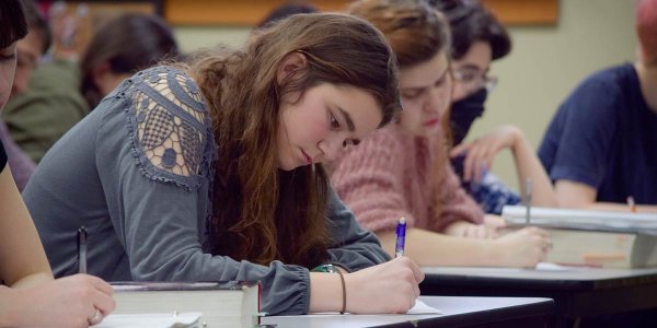 Student taking notes while in class