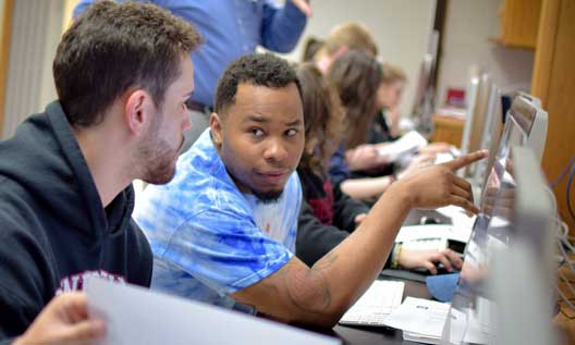 Students work on a computer in a classroom