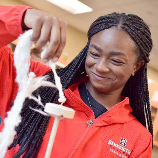 A student works with string in biology class