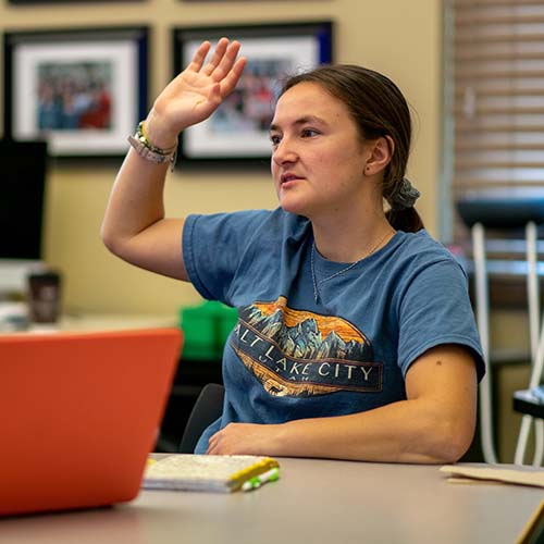 A student raises her hand in class