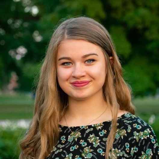 A student smiles at the camera