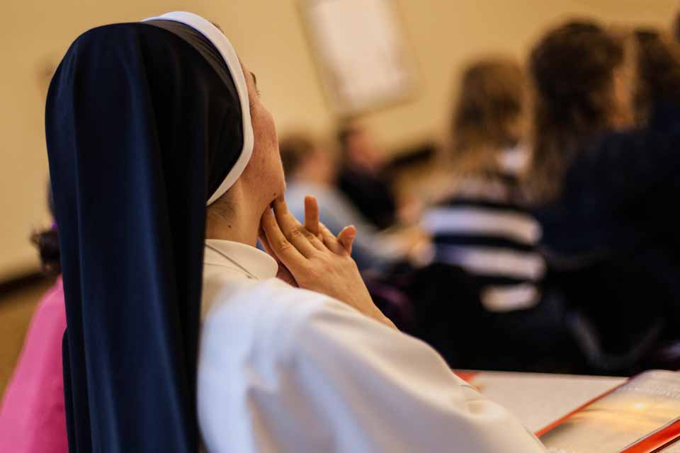A religious sister listens to a presentation at the Symposium