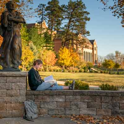 A student reading on campus