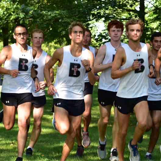 Men cross country team running in a pack