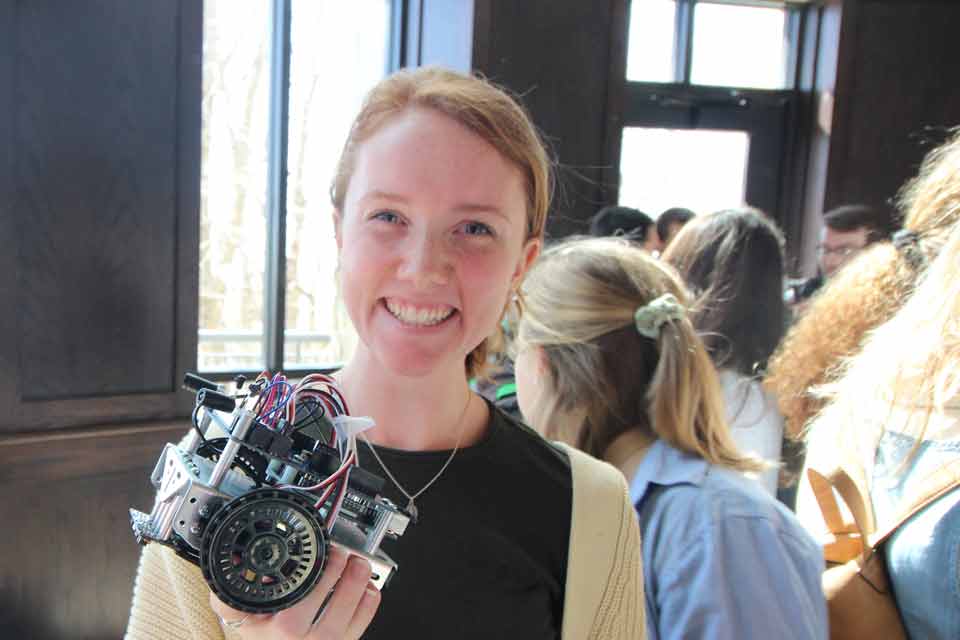 A student holds a battle bot during Discovery Day