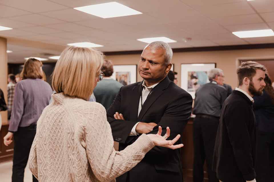 Attendees conversing at the Symposium on Transforming Culture