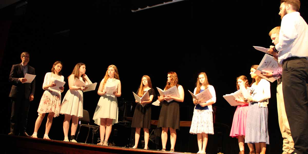 Students singing on stage