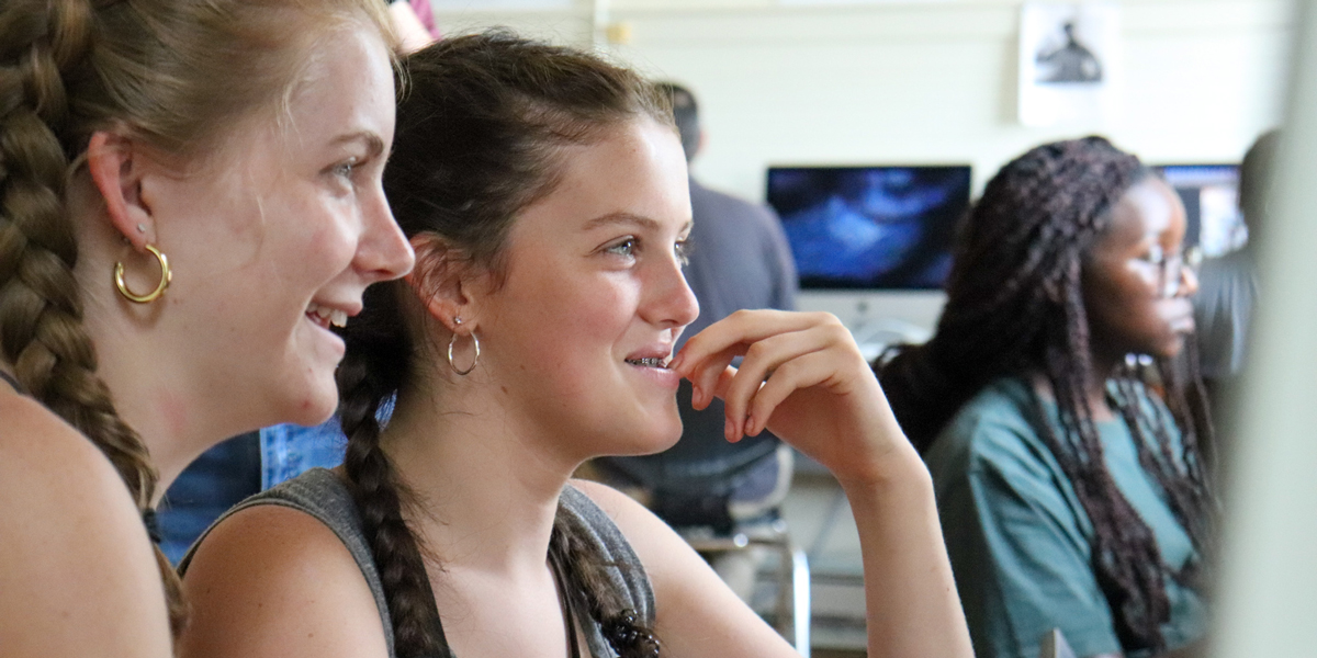 Two computer science students smile 