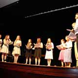 Students singing on stage