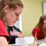 A BCYC Immersion student taking notes in class