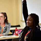 A BCYC Immersion participant raises her hand in class