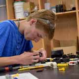 A BCYC Immersion student assembles an engineering project in class