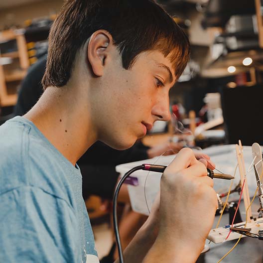 BCYC student soldering a wire