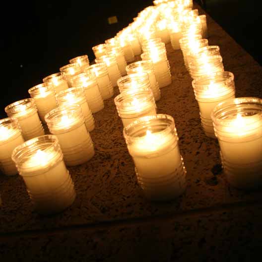 Lit candles for Mary's Grotto spread across the floor