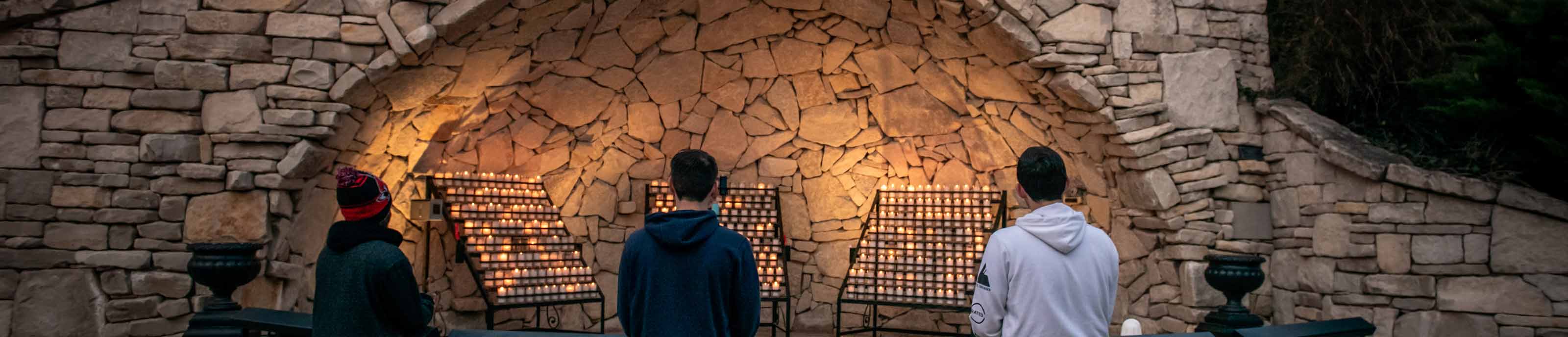 Students praying at Mary's Grotto