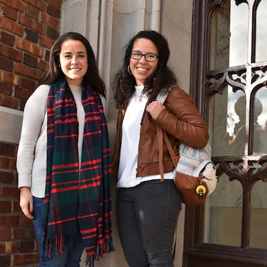 Students smiling in front of Benedictine Hall