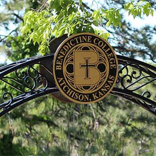 The Benedictine College Seal in an iron archway