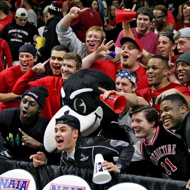 Rocky Raven with cheering students at a sporting event