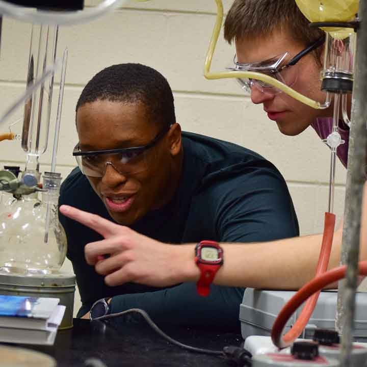 Two students working in a chemistry lab