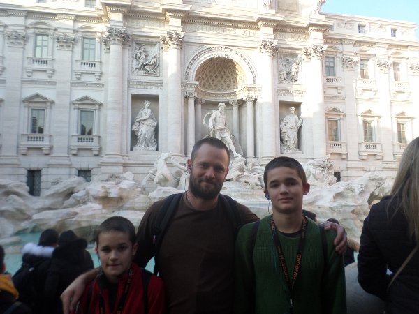 Dr. Jamie Blosser at the Trevi Fountain in Rome with his sons, Ambrose (left) and Augustine.