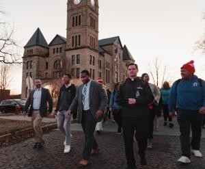 Dean of Students Joseph Wurtz, Director of Student Support and Engagement Tyler Shephard, and College Chaplain Fr. Ryan Richardson lead the MLK Day March from the Atchison Courthouse.