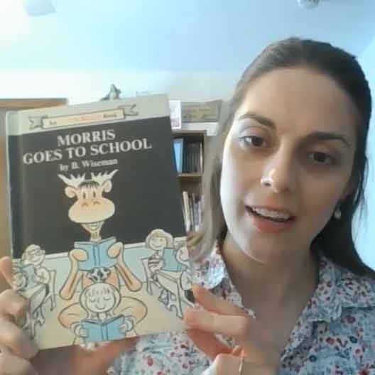 Director of Service-Learning Meredith Stoops holds a copy of Morris Goes to School