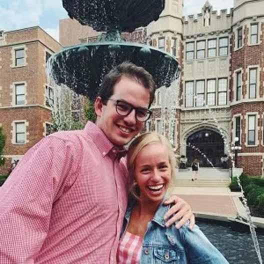 Joseph Roberts stands with his sister Molly in front of Our Lady of Grace Fountain