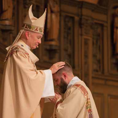 Archbishop George Lucas ordains Father Tucker ’12