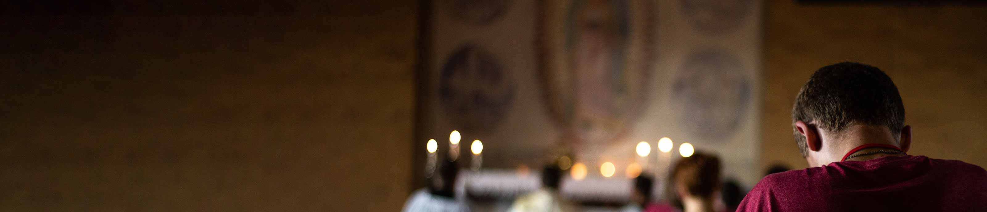 A student praying in a chapel