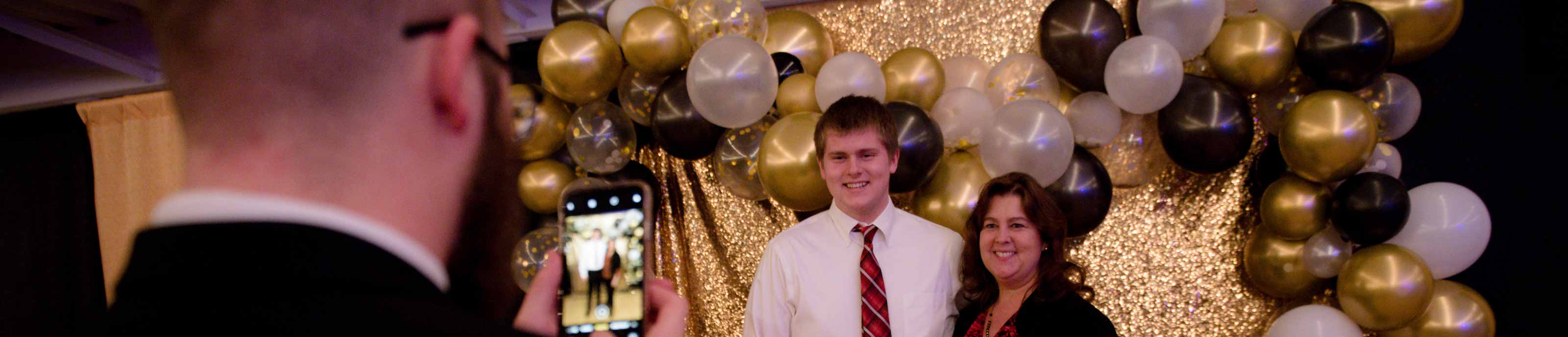 A mother and son pose for a photo at the Mother-Son Father-Daughter Banquet & Dance