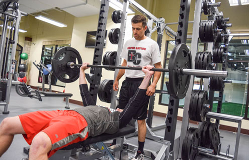 Personal Trainer spotting a weightlifter