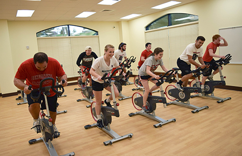 Students cycling on stationary bikes