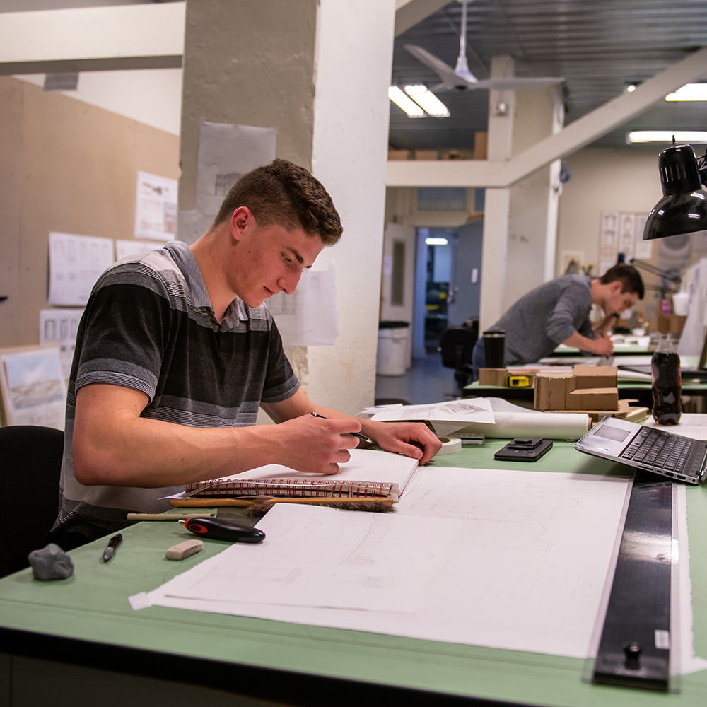 Students working at architecture drafting tables