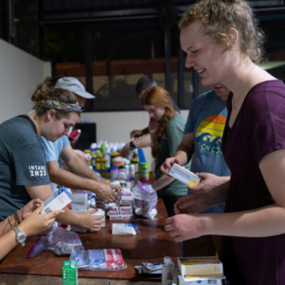 Students organize medical supplies while on a mission trip