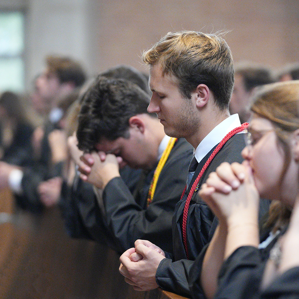 Students praying at Baccalaureate Mass