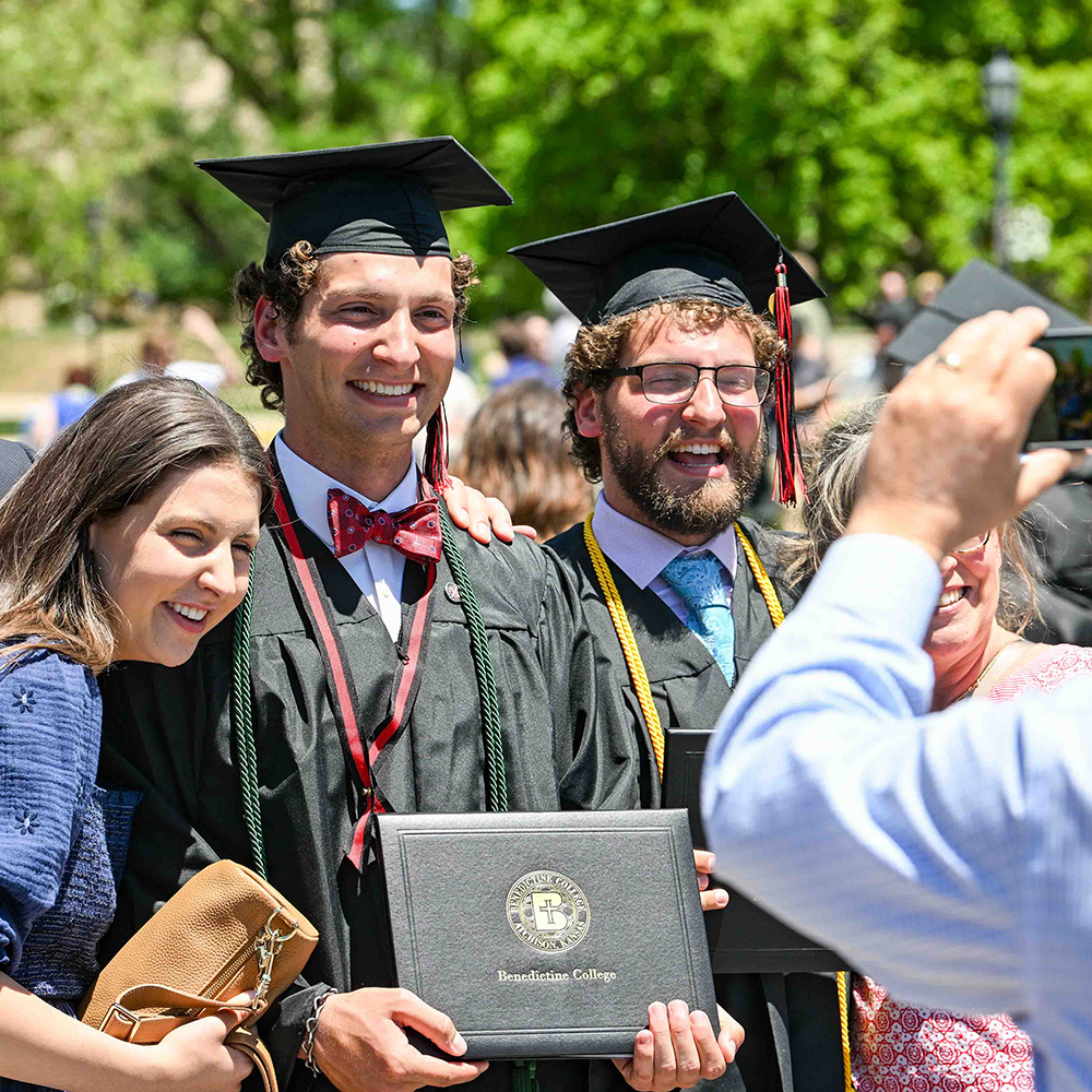 Graduates pose for a photo with family after Commencement