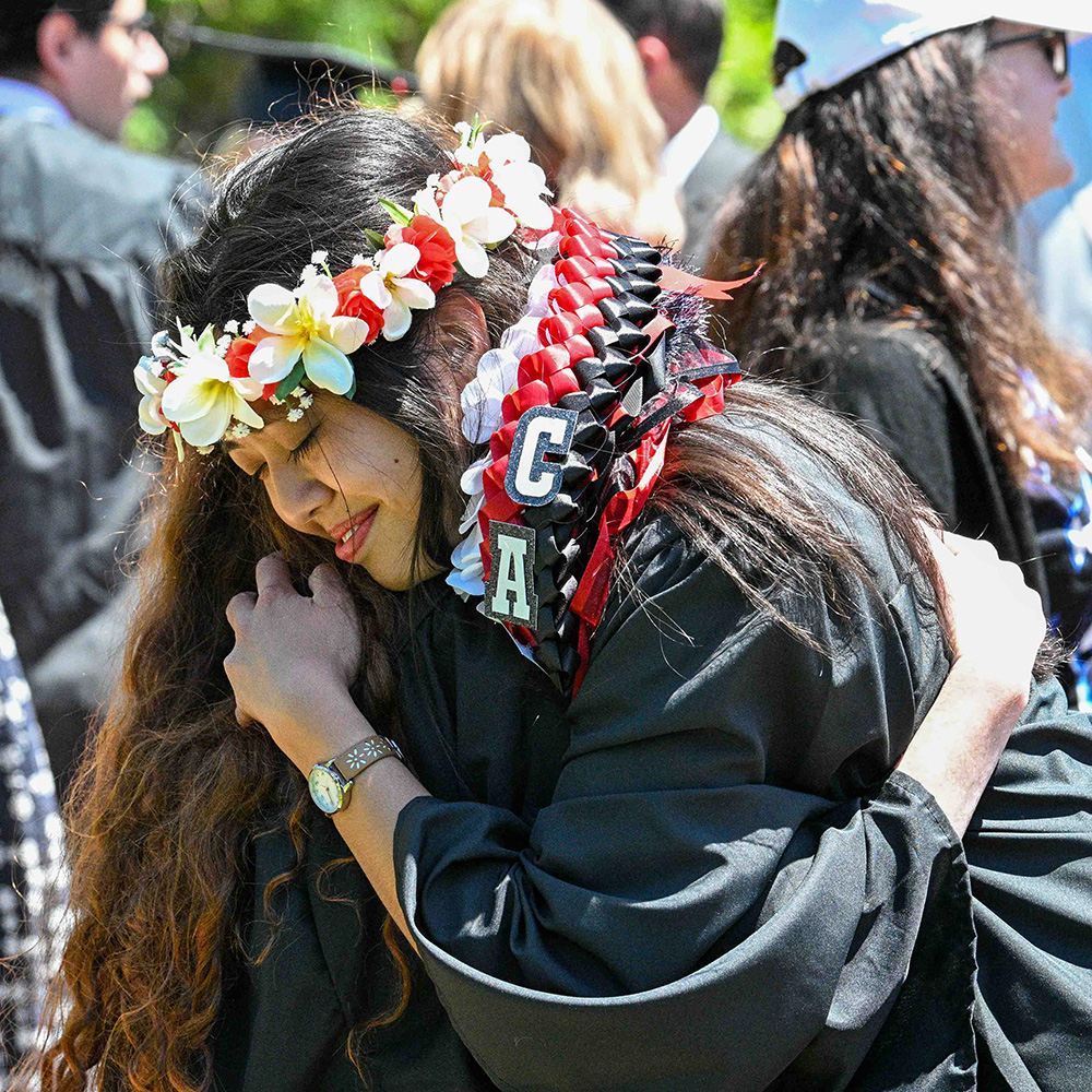 Graduates celebrate with their families in Raven Memorial Park
