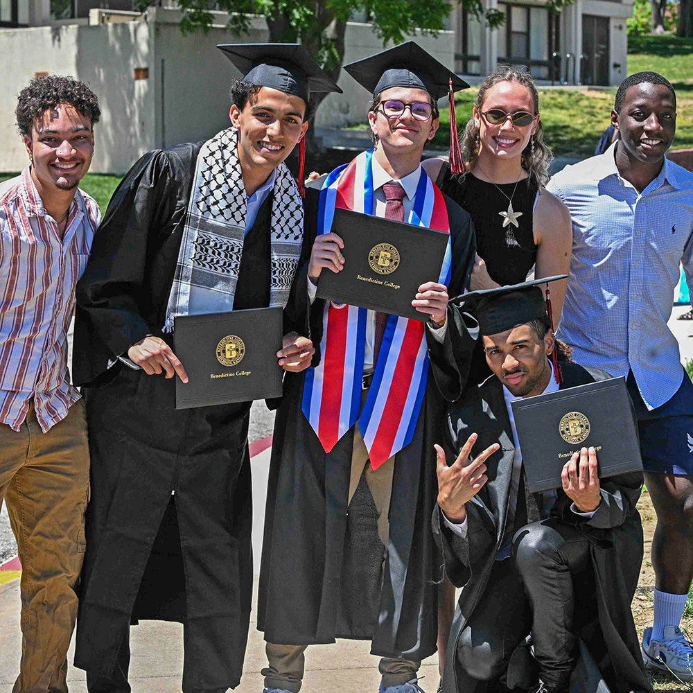 Graduates pose for a photo after Commencement
