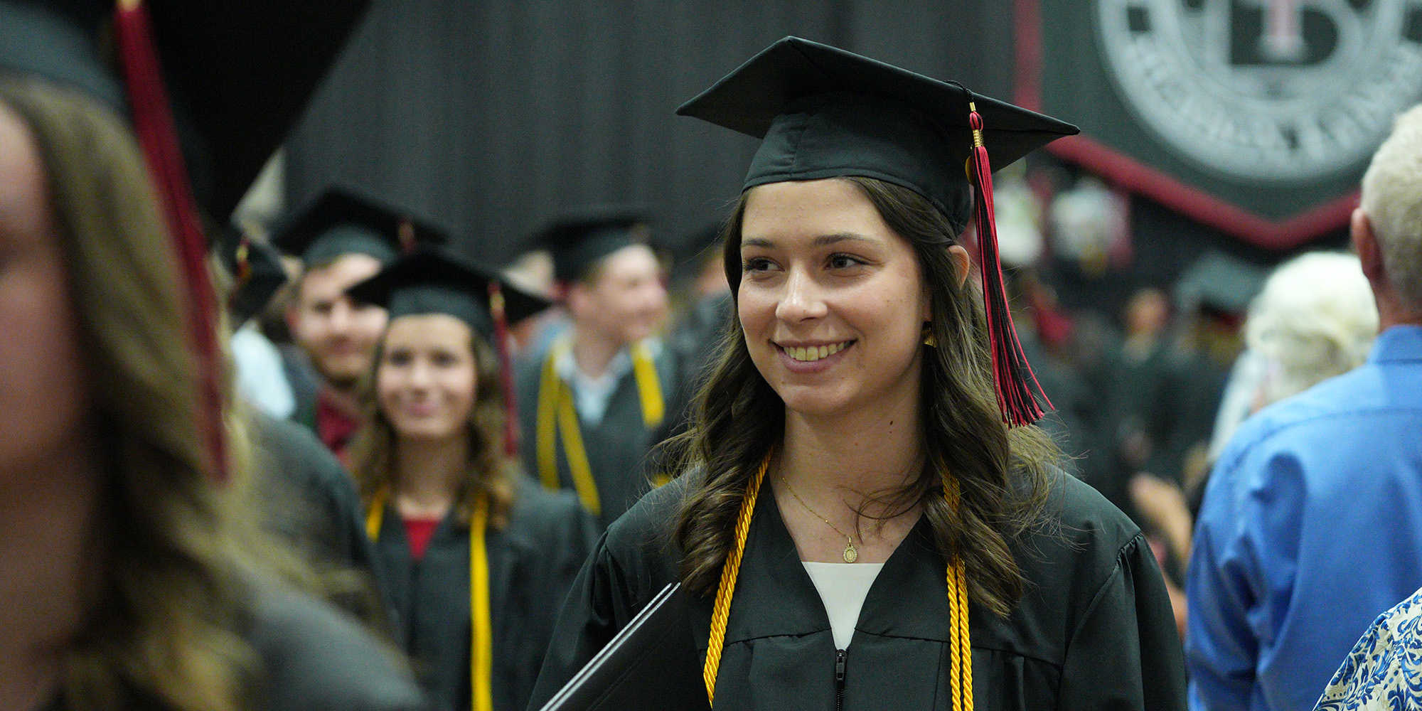 A graduate after receiving her diploma at the Commencement ceremony