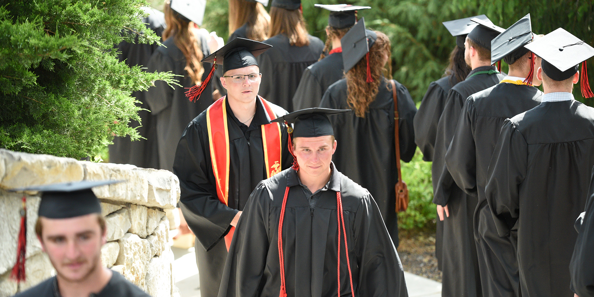 Graduates exiting Mary's Grotto during the March of Light
