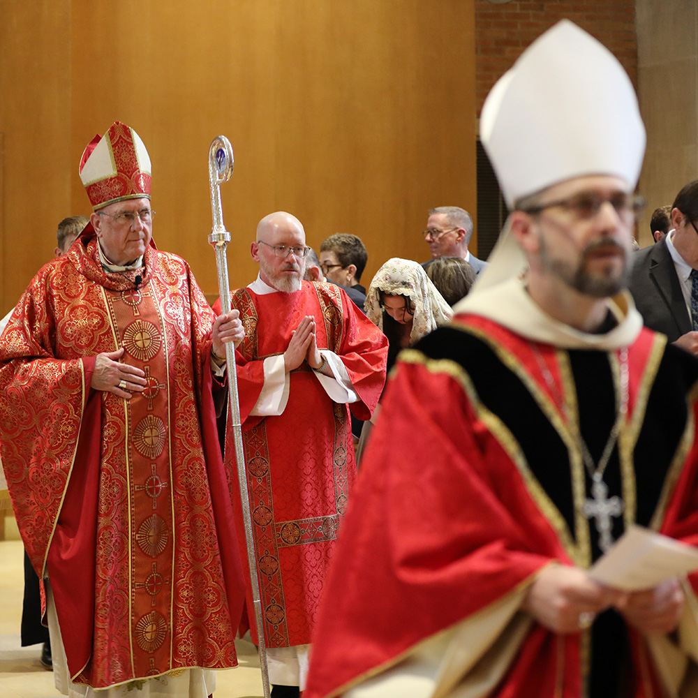Archbishop Emeritus Joseph Naumann processes into the Baccalaureate Mass